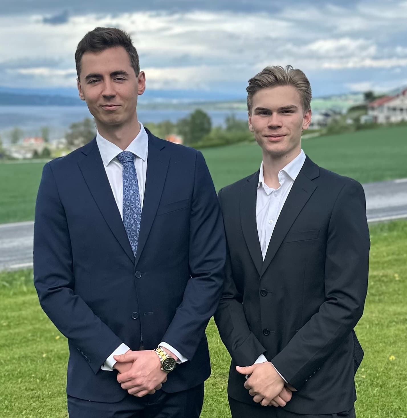 Oskar and Louis Solberg standing by a fjord