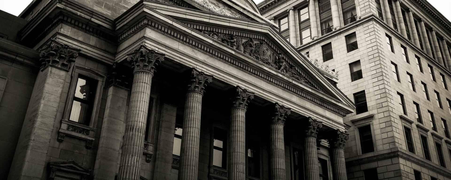 Black-and-white view of a classical bank building with columns