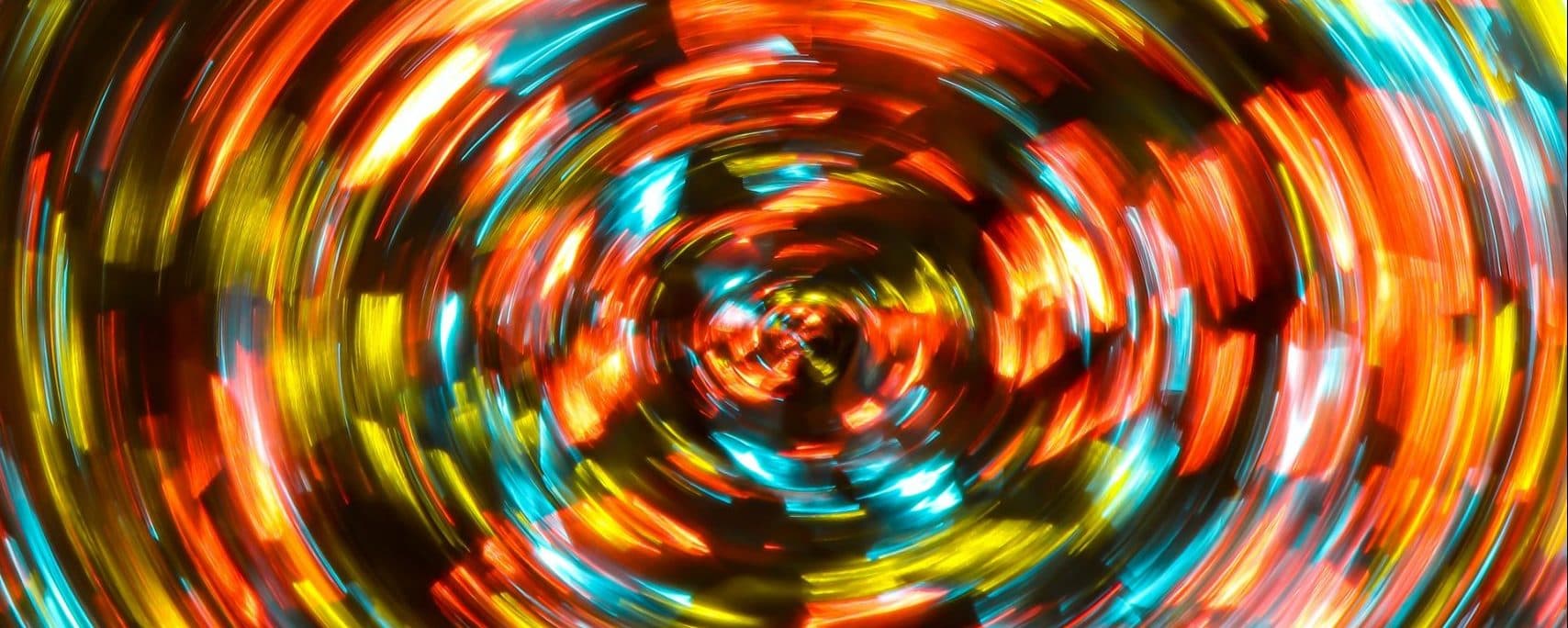 Abstract spiral of red, yellow, and blue light trails