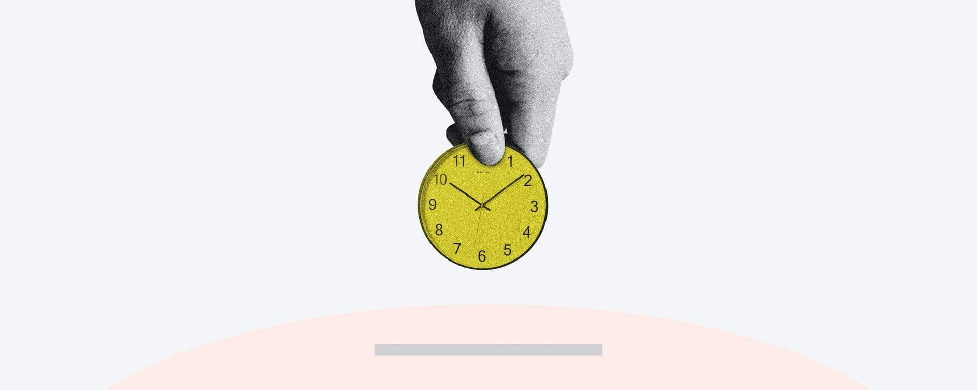 Hand holding a yellow clock against a white background