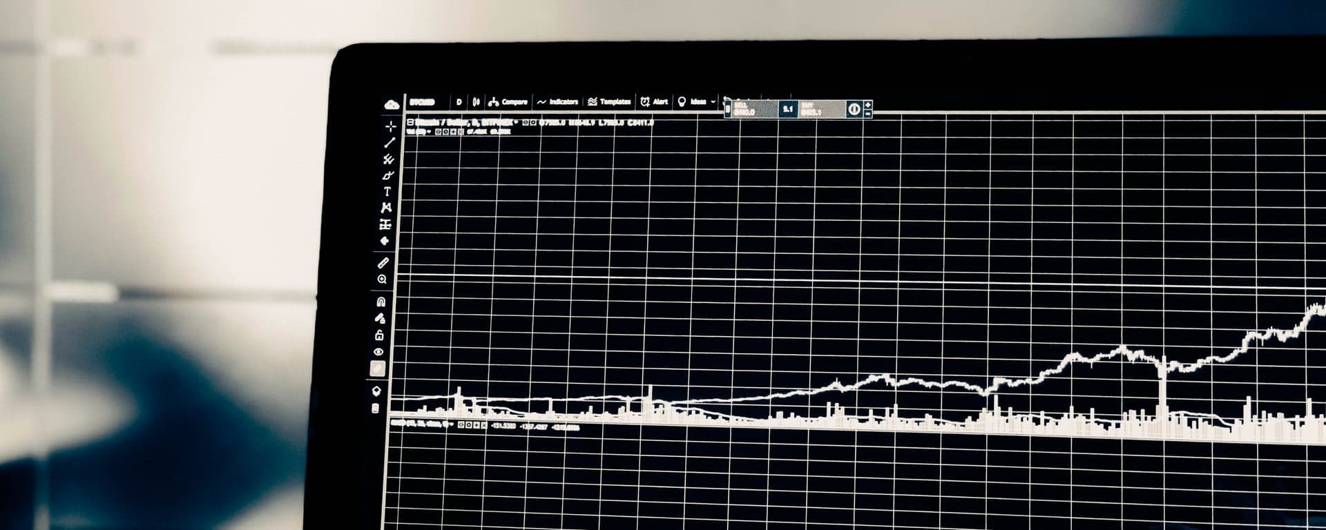 Laptop screen displaying a cryptocurrency price chart in TradingView
