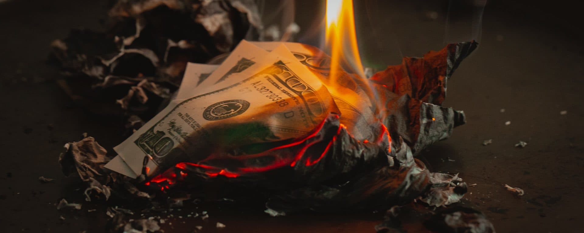 U.S. $100 bills burning in a fire